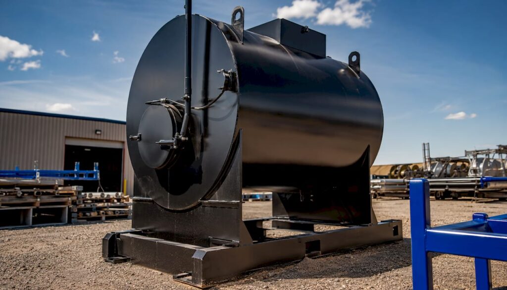 Steel industrial waste tank at facility with branded logo